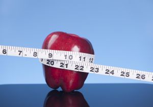Tape measure and apple.