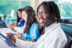 Young male nursing student smiling during medical college class