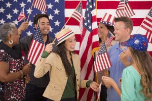 Multi-ethnic group. American people at political rally. USA flags. Voting.