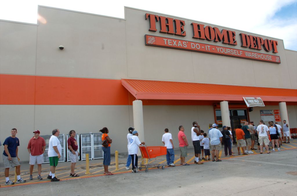 Residents of Houston, Tex., line up outside a Home Depot, on