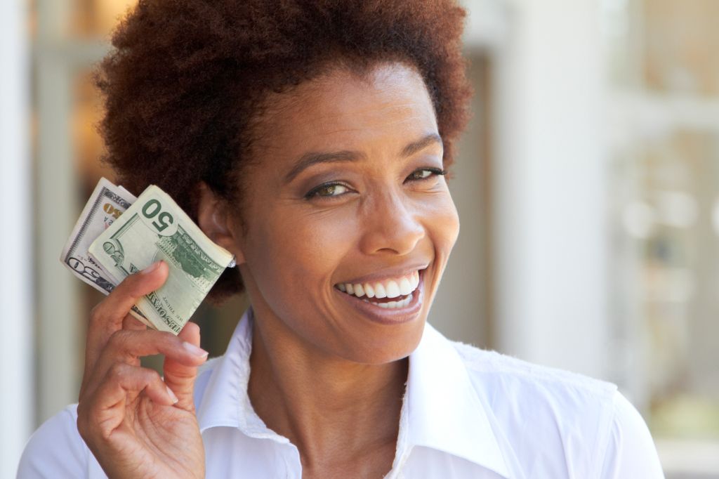 African American woman holding 50 dollar bill