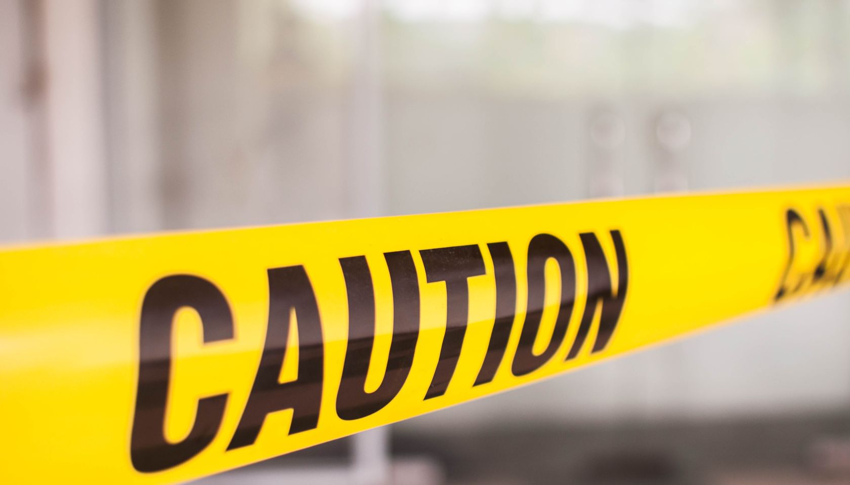 Yellow tape with caution sign