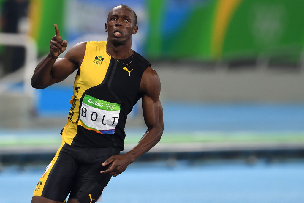 Usain Bolt of Jamaica reacts at the end of the men's 100m...
