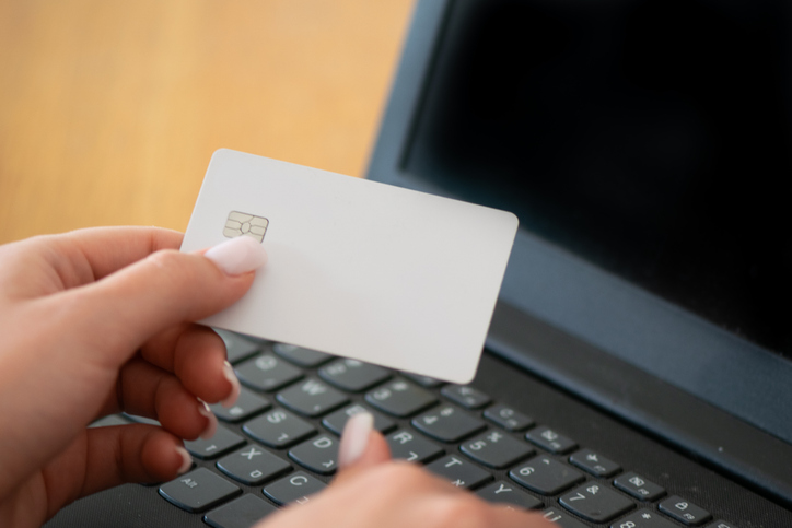 Blank credit card in female hand, concept of online payment and banking
